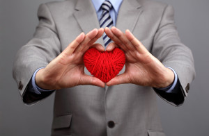 Man holding a red woolen heart concept for valentine's day, busi
