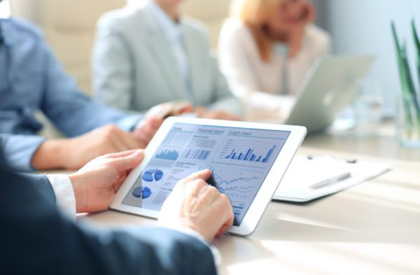 Business person analyzing financial data displayed on the tablet screen