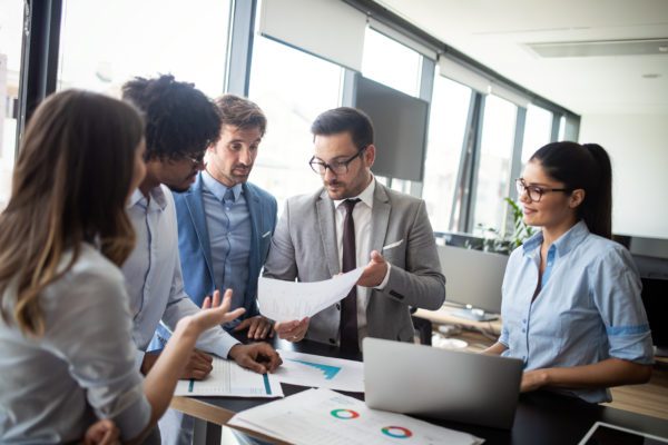 Group of employees gathered in business office