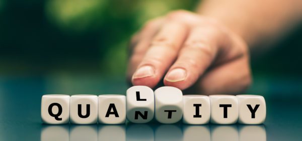 Quality instead of quantity concept. Hand turns dice and changes the word "quantity" to "quality".