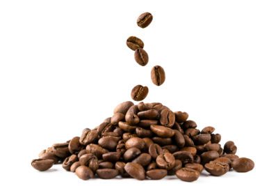 A bunch of coffee beans and falling coffee beans on a white background, close-up. Isolated.
