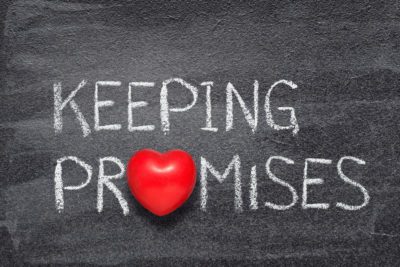 keeping promises phrase written on chalkboard with red heart symbol
