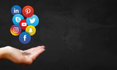Outstretched hand with multiple social media platform logos hovering above the hand